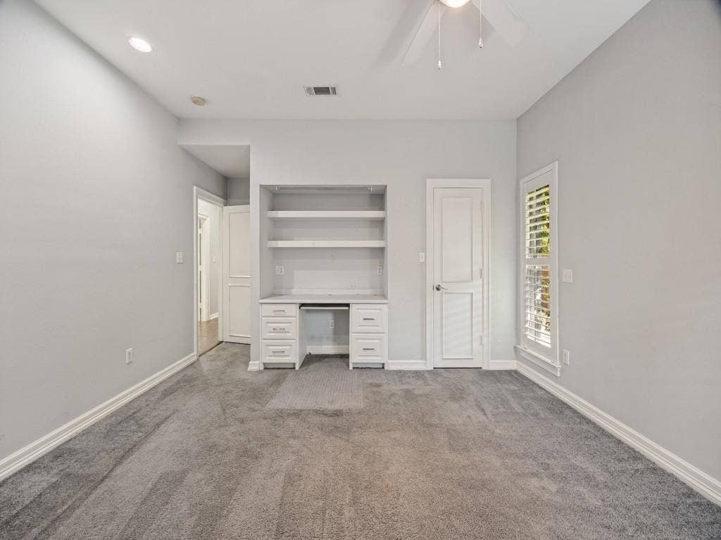 5718 Trail Meadow Drive, Dallas, TX 75230 Bedroom with built-in desk and shelving