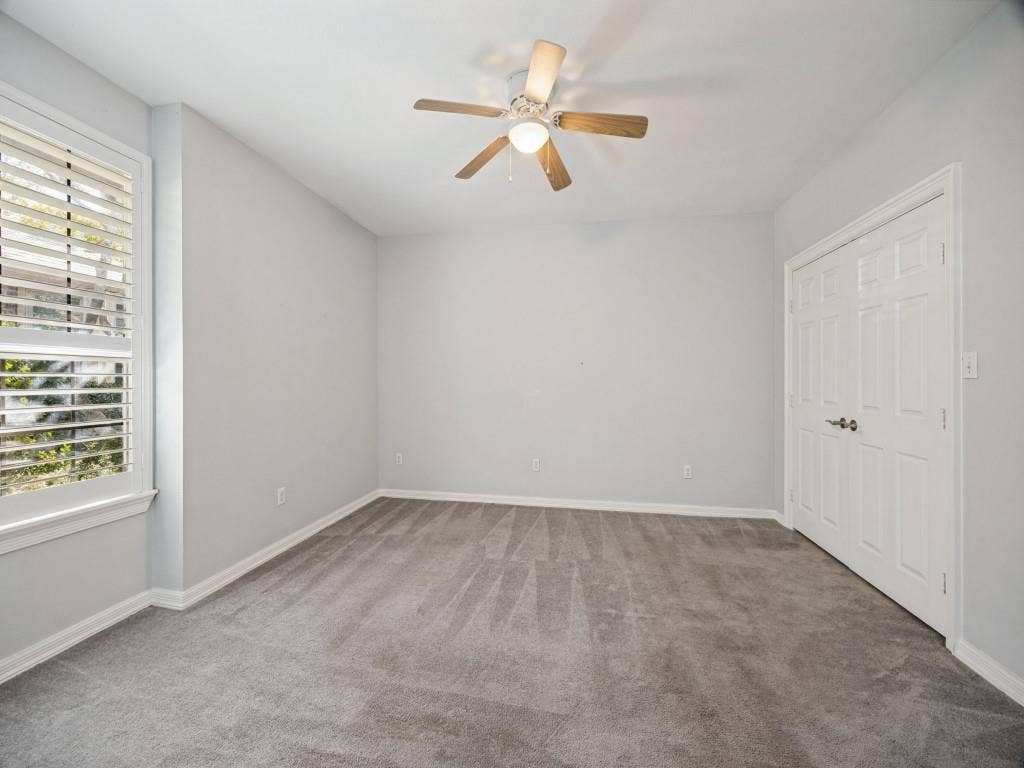 5718 Trail Meadow Drive, Dallas, TX 75230 Bedroom with ceiling fan and double-door closet