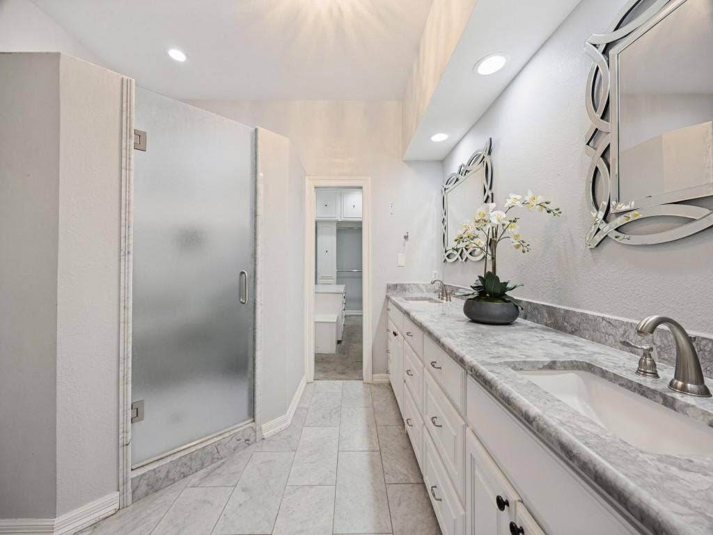 5718 Trail Meadow Drive, Dallas, TX 75230 Marble-tile primary bath leads to the walk-in closet