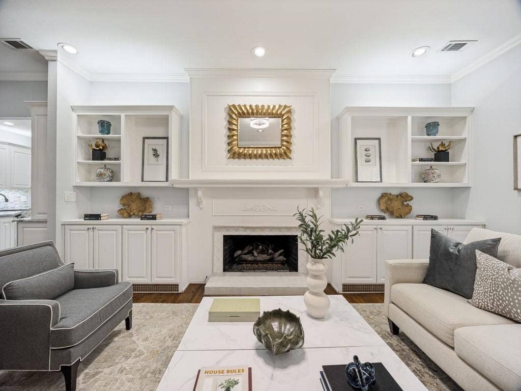 5718 Trail Meadow Drive, Dallas, TX 75230 Fireplace with detailed mantel and built-in shelving