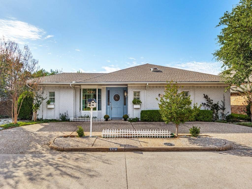 5718 Trail Meadow Drive, Dallas, TX 75230 Classic painted-brick home framed by mature trees and a circular drive