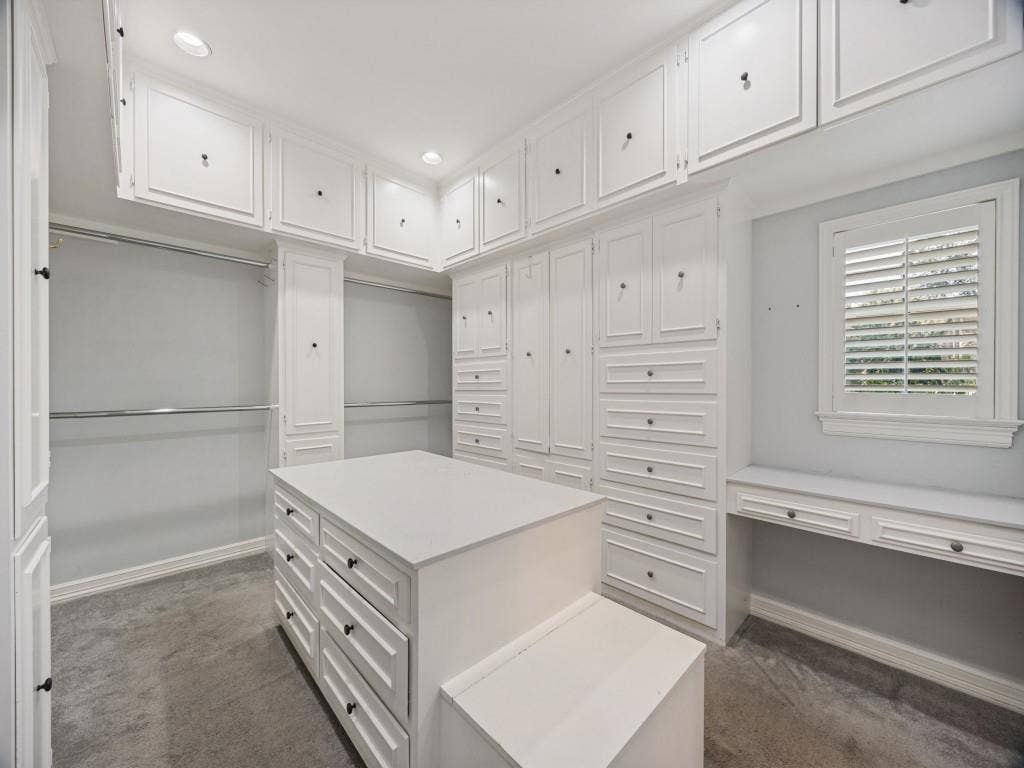 5718 Trail Meadow Drive, Dallas, TX 75230 Custom primary closet with center island, built-in drawers and vanity