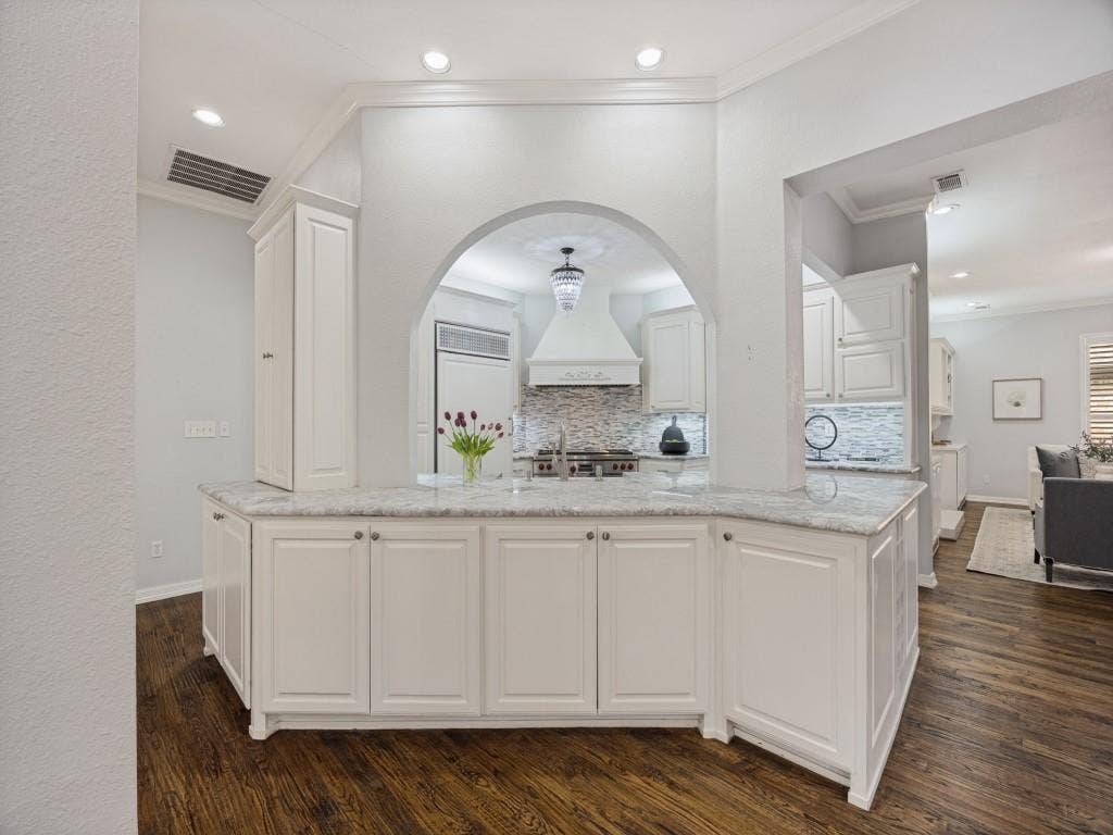5718 Trail Meadow Drive, Dallas, TX 75230 Chef’s kitchen with Wolf range, custom vent hood and mosaic backsplash