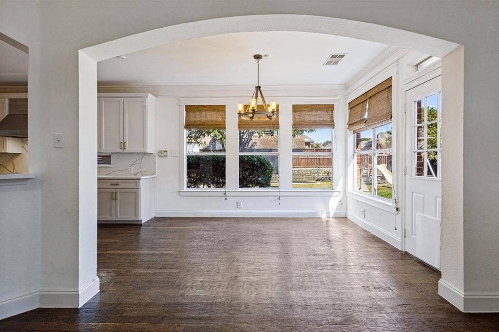 DINING AREA SITS OF THE KITCHEN OVERLOOKING THE SIDE YARD AND BACK PATIO AREA