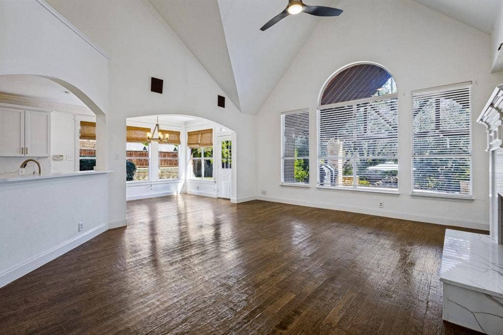 LIVING AREA SITS ON THE BACK OF THE HOME OVERLOOKING A BREATHTAKING BACK YARD WITH POOL AND COVERED PATIO AREA
