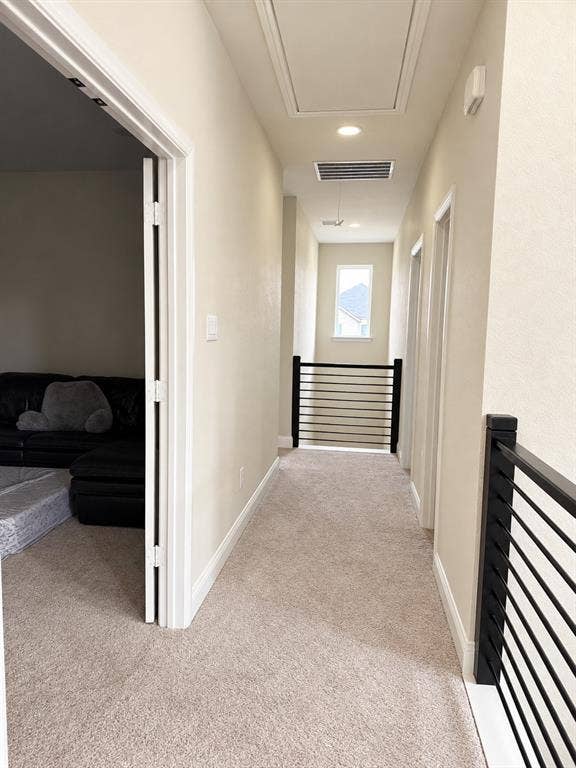 10755 Wells Branch Road, Frisco, TX 75035 Light-toned wall paint, recessed lighting, carpeted hallway, and black metal railings