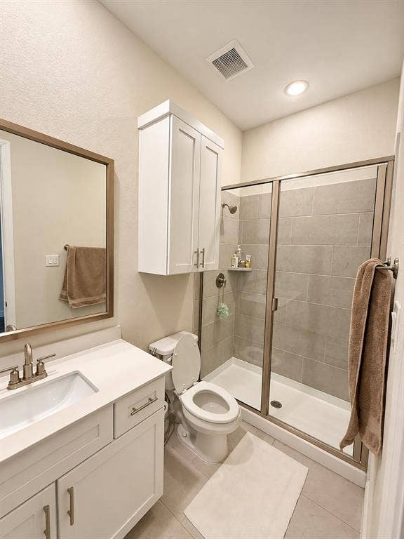 10755 Wells Branch Road, Frisco, TX 75035 White vanity with a rectangular undermount sink, brushed nickel faucet, and a large framed mirror