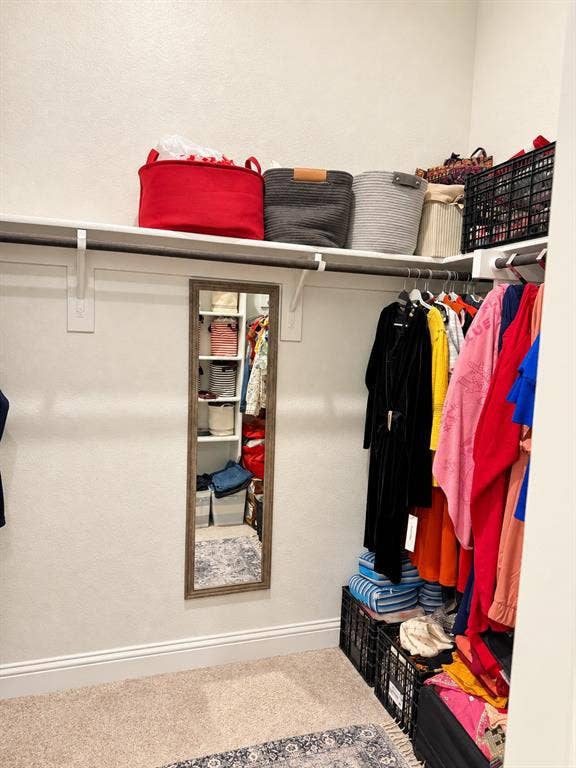 10755 Wells Branch Road, Frisco, TX 75035 Built-in shelving with hanging rods and neutral carpet flooring