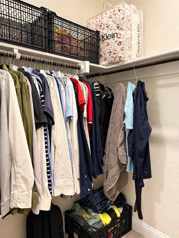 10755 Wells Branch Road, Frisco, TX 75035 Integrated shelving system with multiple hanging rods, upper storage shelves, and neutral wall tones