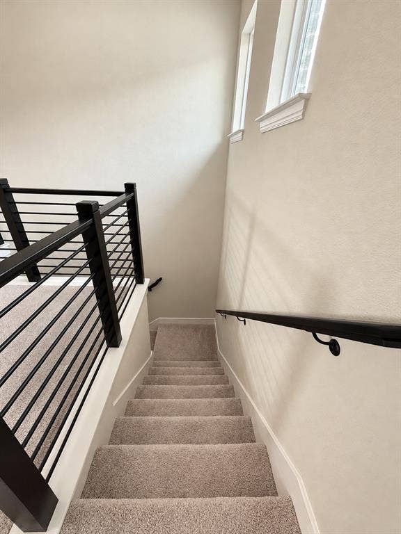 10755 Wells Branch Road, Frisco, TX 75035 Carpeted staircase with contemporary metal balusters and a contrasting handrail