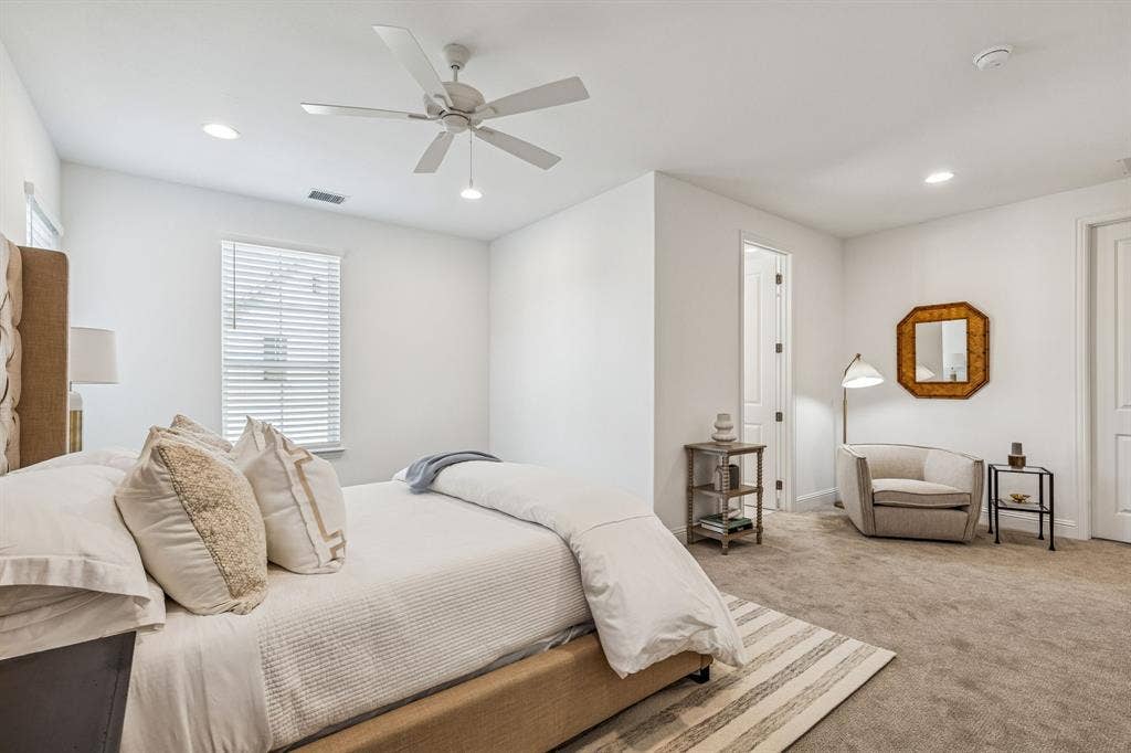 Plush carpeting, recessed lighting, and a ceiling fan with light fixture