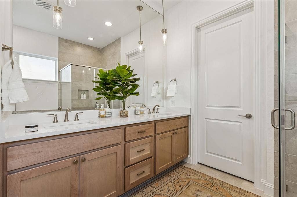Dual vanity with undermount sinks and light wood-finish cabinetry