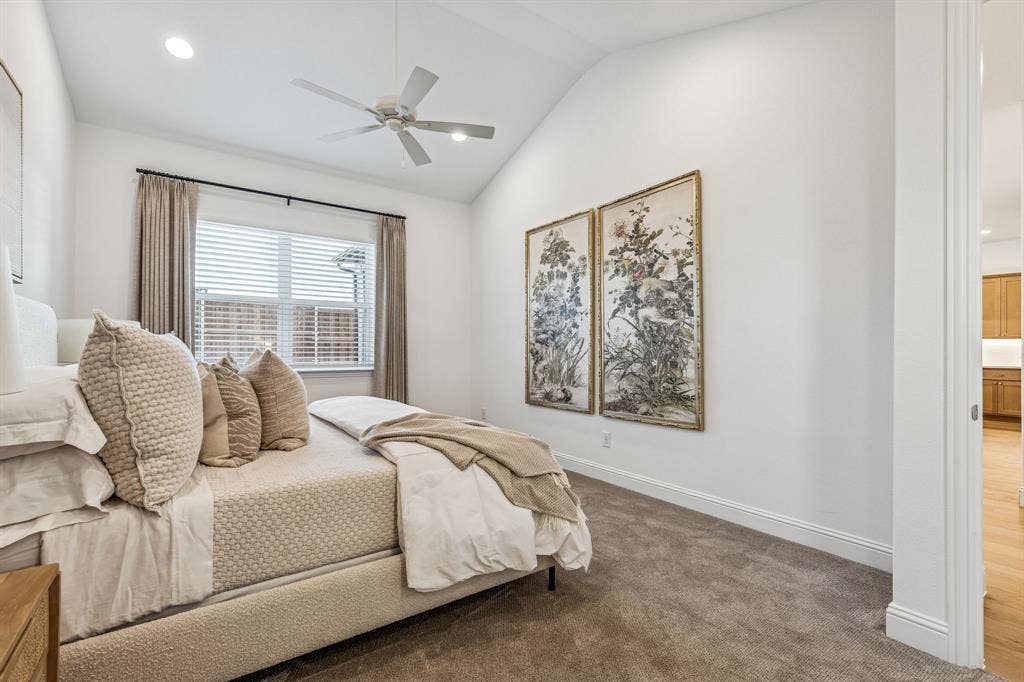 Vaulted ceiling with recessed lighting, ceiling fan, and carpeted flooring