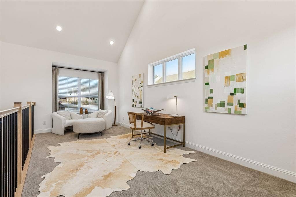Vaulted ceiling with recessed lighting, large window with blinds, additional high window, carpeted flooring, and a wood-finish railing with black balusters