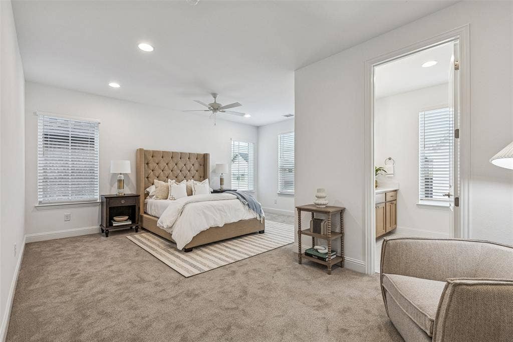 Carpeted flooring, recessed lighting, ceiling fan, multiple windows with blinds, and white interior doors