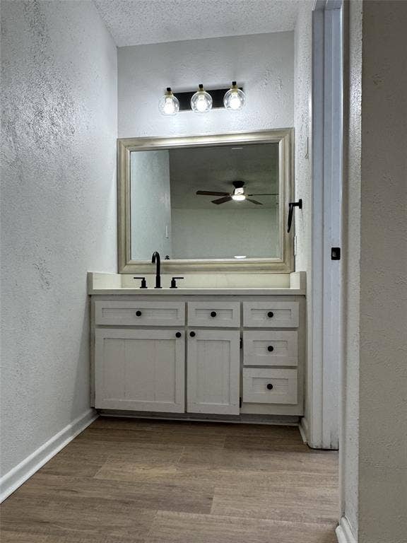 Vanity with matte black fixtures, framed mirror, and built-in cabinetry with black hardware