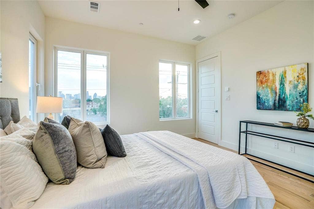 1612 Bennett Avenue, #105, Dallas, TX 75206 Bedroom featuring light wood-finish flooring, white walls, and a multi-pane window configuration