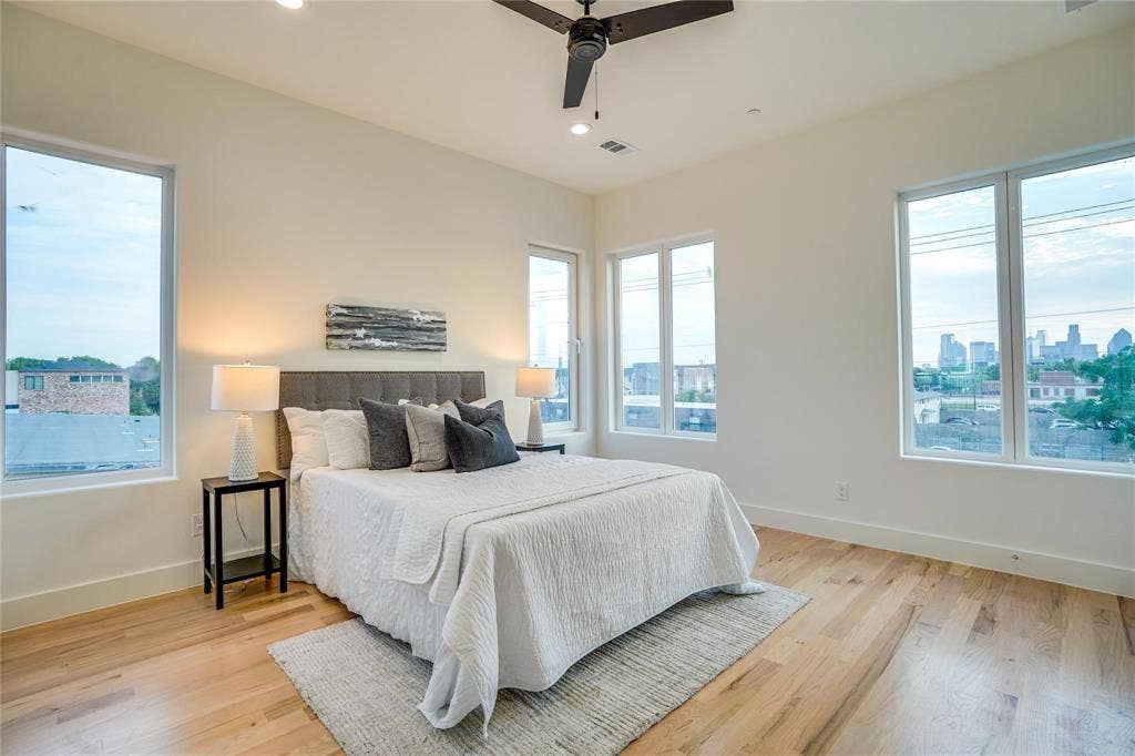 1612 Bennett Avenue, #105, Dallas, TX 75206 Room featuring expansive windows with cityscape scenery, wood-finish flooring, a contemporary ceiling fan, and recessed lighting