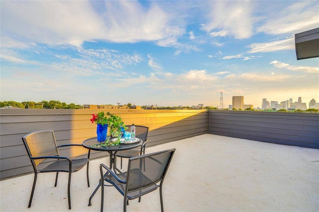 1612 Bennett Avenue, #105, Dallas, TX 75206 Expansive rooftop deck featuring a light-colored concrete surface and a dark gray horizontal plank fence