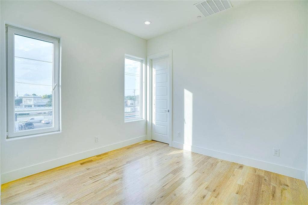 1612 Bennett Avenue, #105, Dallas, TX 75206 Room featuring light wood-finish flooring, white walls, and bright overhead lighting
