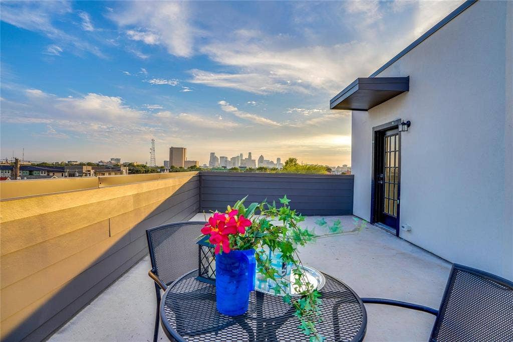1612 Bennett Avenue, #105, Dallas, TX 75206 Rooftop terrace featuring a concrete surface, a black framed glass-paned door, and a protective awning