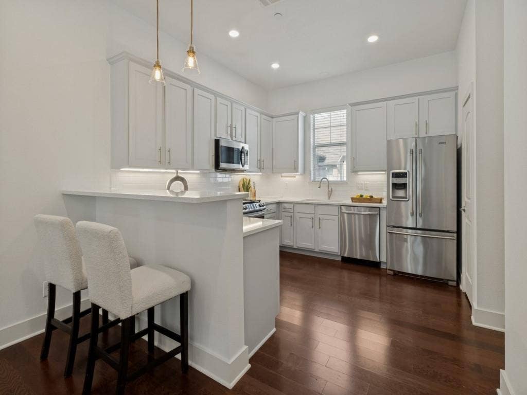 Updated kitchen with quartz, stainless steel appliances and gas range