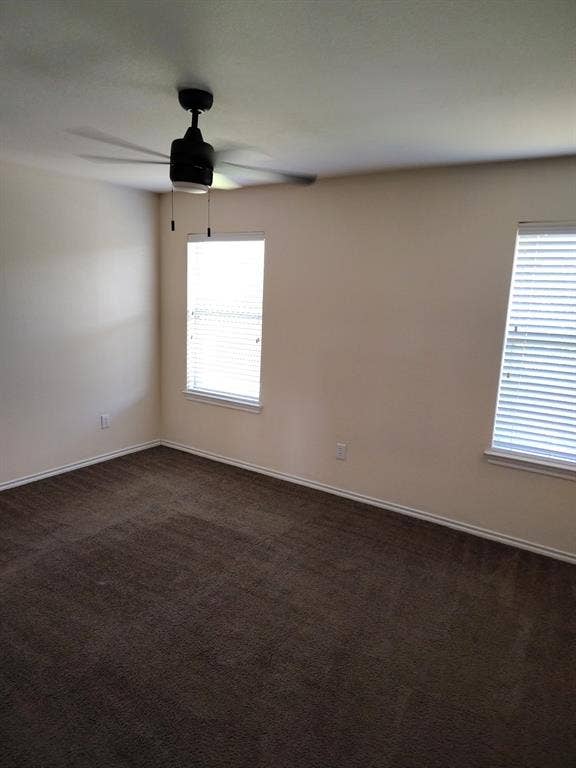 Plush carpet flooring, neutral-toned walls, and a ceiling fan with integrated lighting