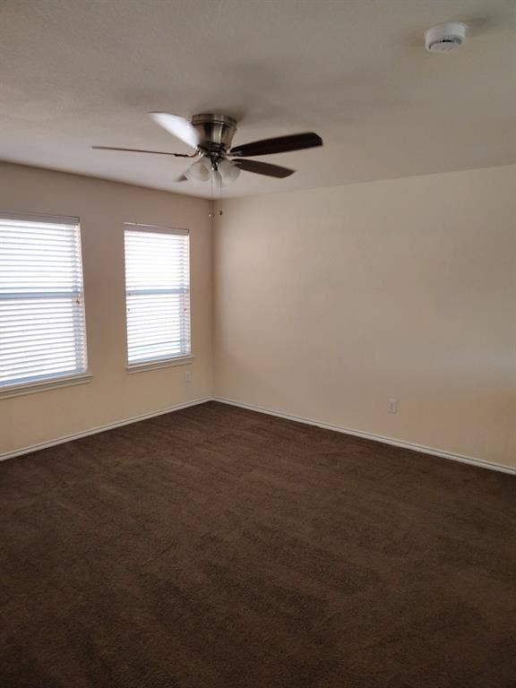 Recessed windows with blinds, ceiling fan with light fixture, and wall-to-wall carpeting
