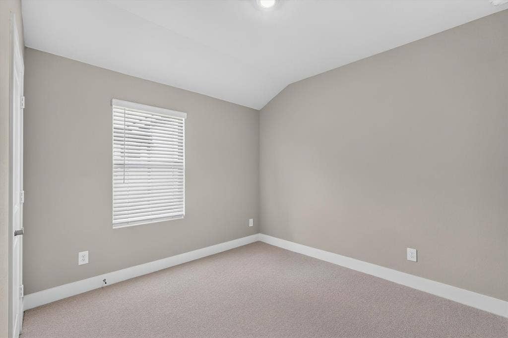 6108 Chickney Drive, Princeton, TX 75071 Neutral-toned room featuring high vaulted ceilings, wall-to-wall carpeting, and a single-hung window with installed horizontal blinds