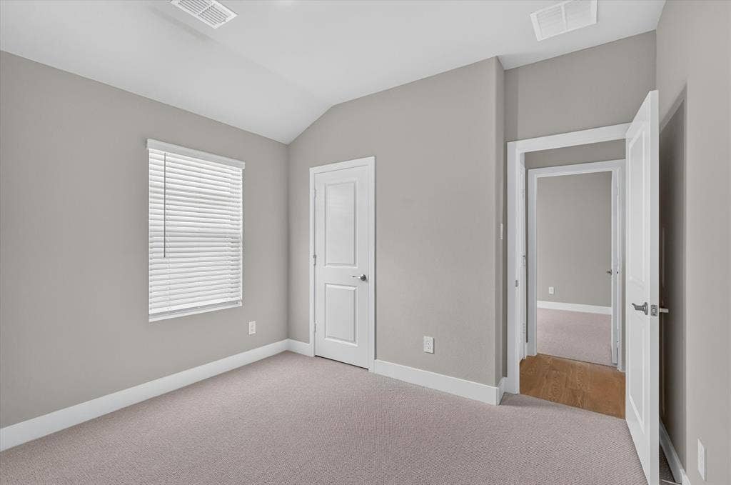 6108 Chickney Drive, Princeton, TX 75071 Room featuring vaulted ceilings, neutral wall tones, wall-to-wall carpeting, and a single window with blinds