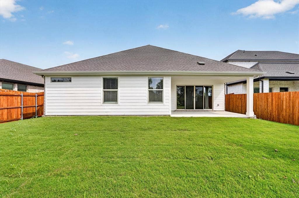 6108 Chickney Drive, Princeton, TX 75071 Backyard featuring horizontal siding, a covered concrete patio, sliding glass doors, and wooden privacy fencing