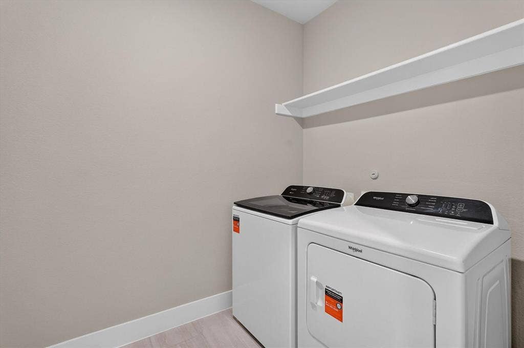 6108 Chickney Drive, Princeton, TX 75071 Utility area featuring wall-mounted shelving and light-toned flooring