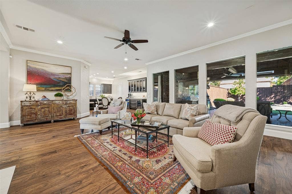 6168 Sweeney Trail, Frisco, TX 75034 Wood-finish flooring, recessed lighting, crown molding, ceiling fan, and large windows