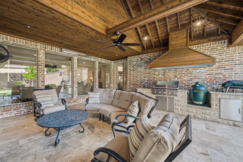 6168 Sweeney Trail, Frisco, TX 75034 Covered outdoor patio with a wood-plank ceiling, exposed wood beams, and a ceiling fan
