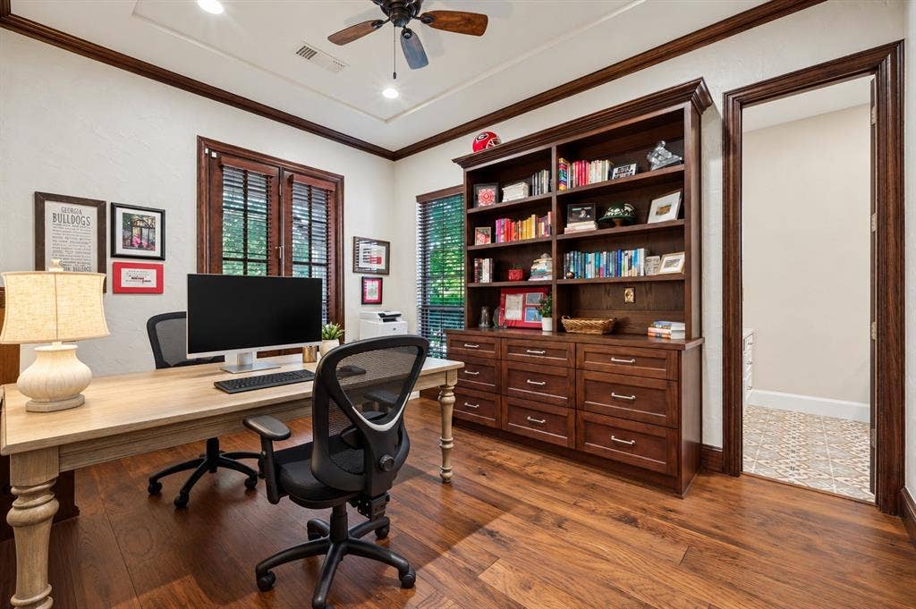 6168 Sweeney Trail, Frisco, TX 75034 Hardwood flooring with a built-in wood-finish bookcase and storage, a tray ceiling, and a ceiling fan