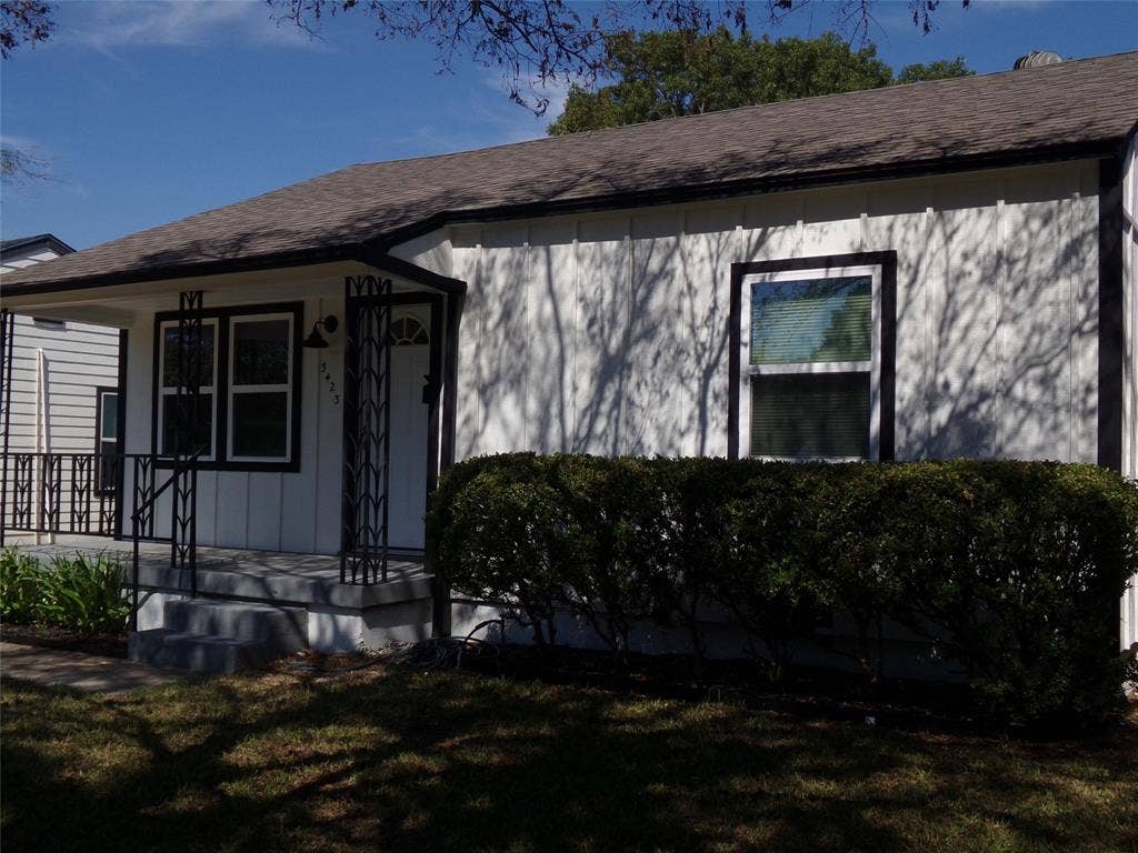 3423 Texas Drive, Dallas, TX 75211 White vertical siding exterior with contrasting dark trim
