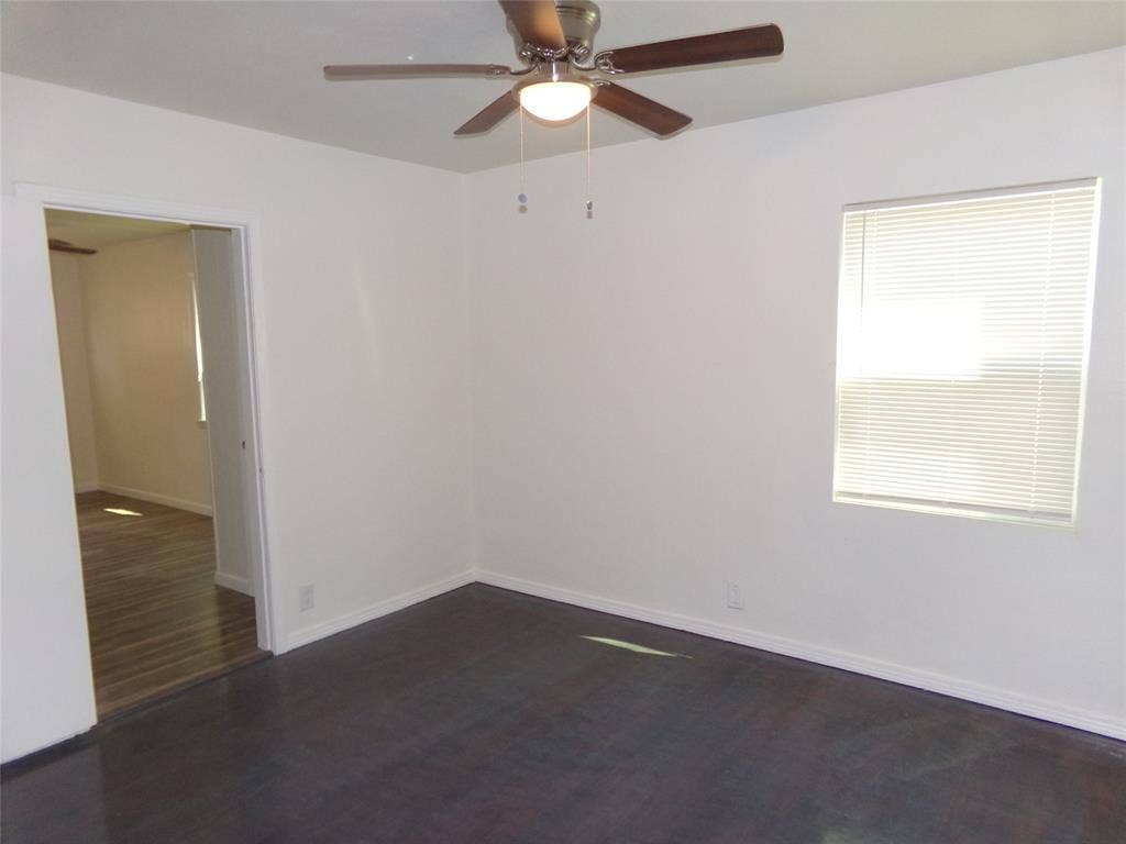 3423 Texas Drive, Dallas, TX 75211 Dark wood-finish flooring, white walls, ceiling fan, and a window with blinds