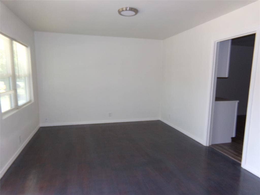 3423 Texas Drive, Dallas, TX 75211 Dark wood-finish flooring with white baseboards