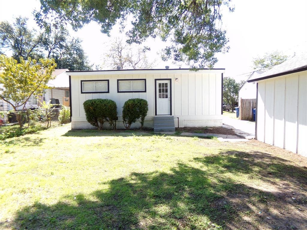 3423 Texas Drive, Dallas, TX 75211 White vertical siding exterior with black trim windows