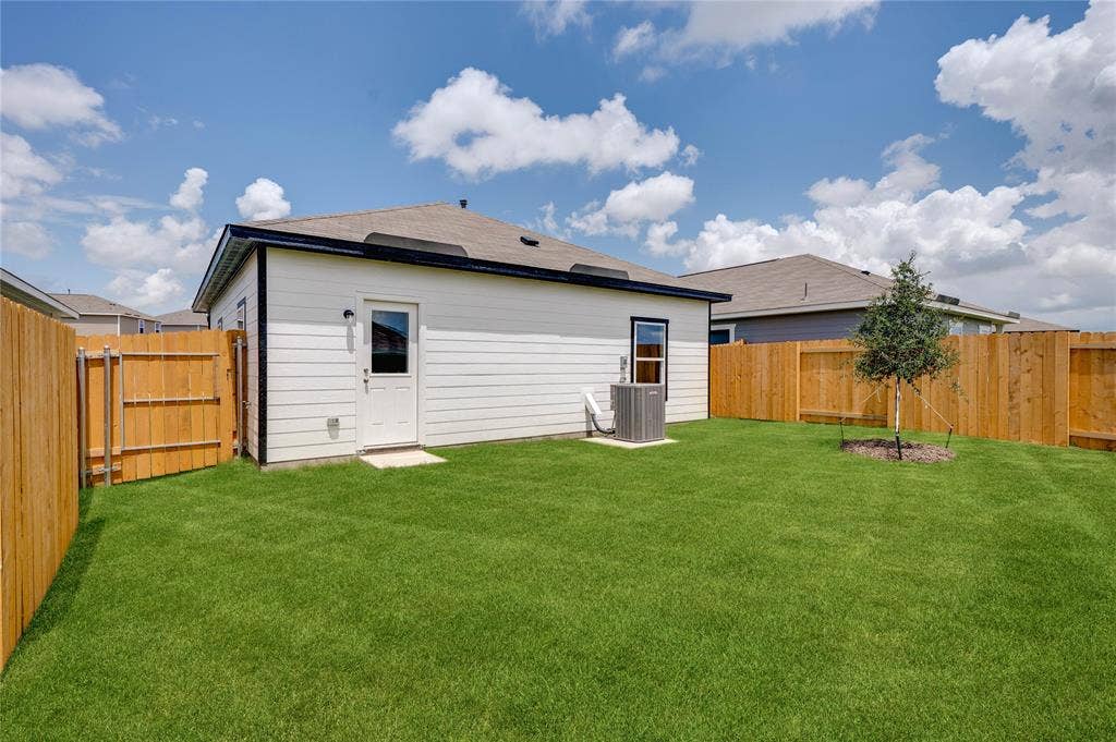 Rear view of property with a fenced backyard