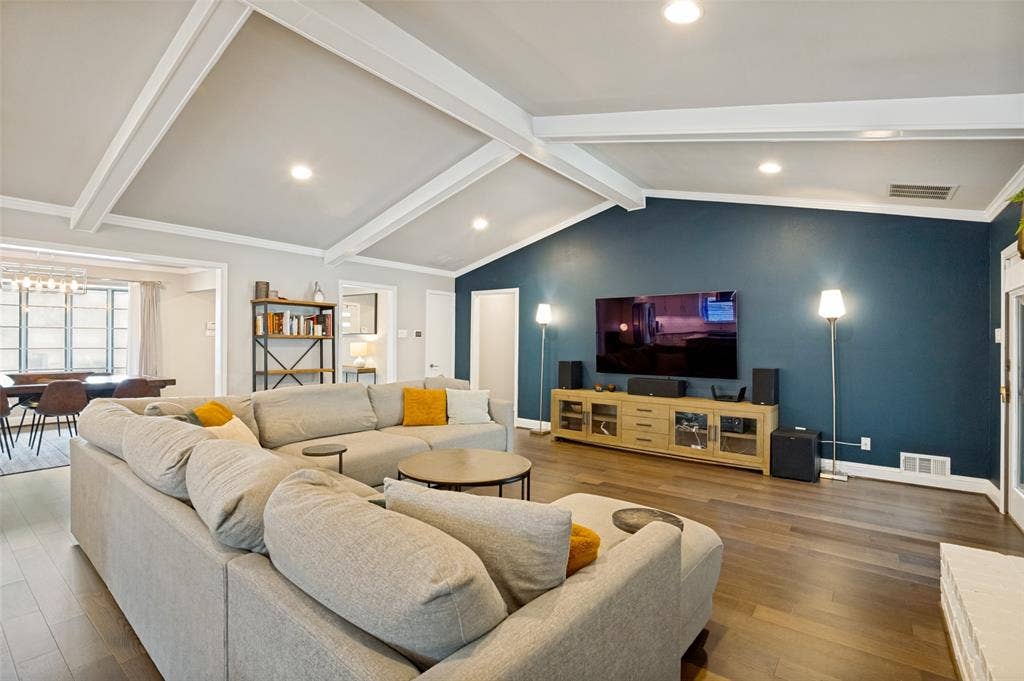 9421 Meadowknoll Drive, Dallas, TX 75243 Spacious living area featuring vaulted ceilings with exposed beams, recessed lighting, and wood-finish flooring
