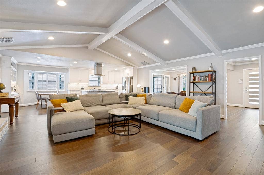 9421 Meadowknoll Drive, Dallas, TX 75243 Spacious living area featuring wood-finish flooring, vaulted ceiling with exposed beams, and recessed lighting