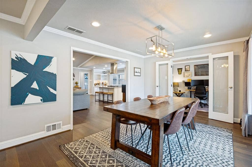 9421 Meadowknoll Drive, Dallas, TX 75243 Dining area featuring wood-finish flooring, a contemporary chandelier, recessed lighting, and crown molding