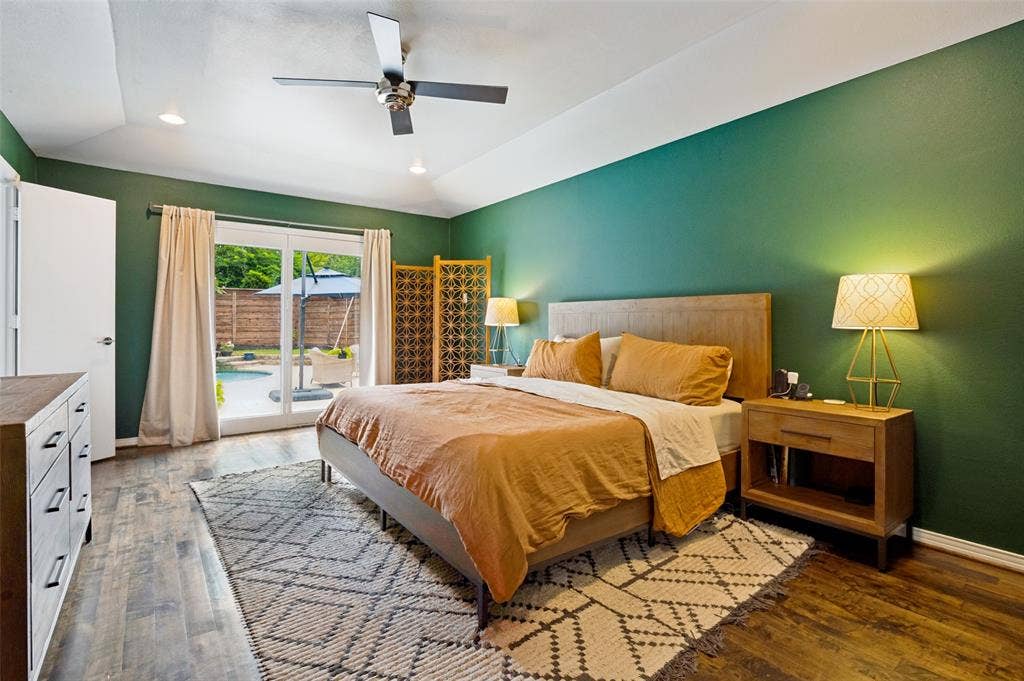 9421 Meadowknoll Drive, Dallas, TX 75243 Spacious room featuring wood-finish flooring, a vaulted ceiling with recessed lighting and a ceiling fan, and direct access to the outdoor area through sliding glass doors