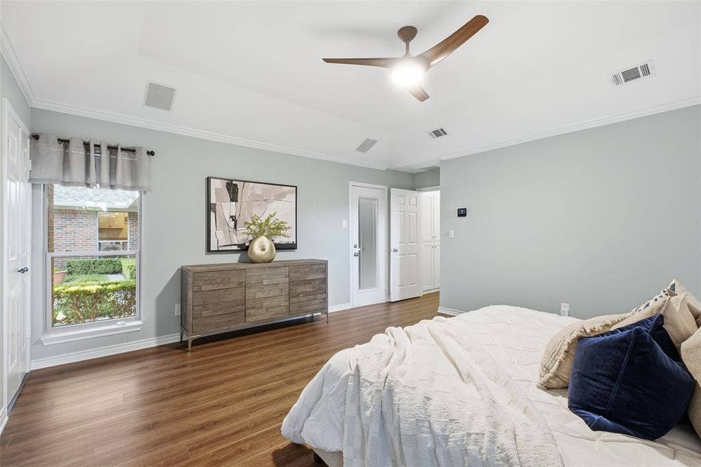 Spacious primary bedroom with natural light and easy access to the spa-style bath.