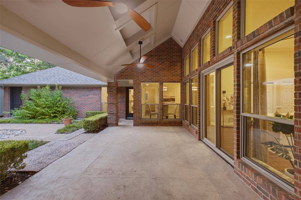 Covered outdoor living with vaulted ceiling and ceiling fans, steps from the living room.