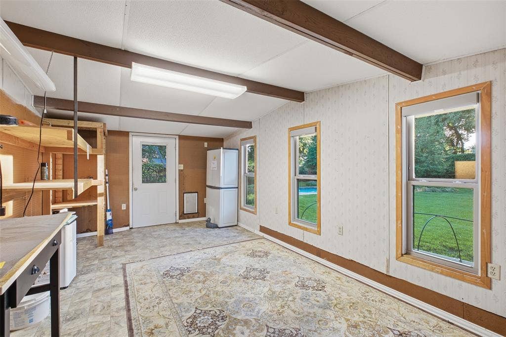 Versatile studio space with windows overlooking the lawn and pool.