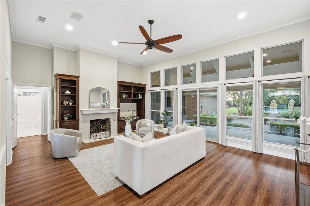 Soaring ceilings, a stately fireplace and custom built-in cabinetry make this living room the heart of the home.