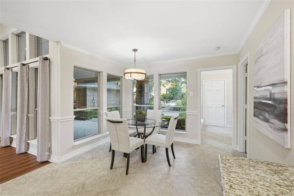 Sun-drenched breakfast nook surrounded with windows on: a bright spot for slow mornings and courtyard views.