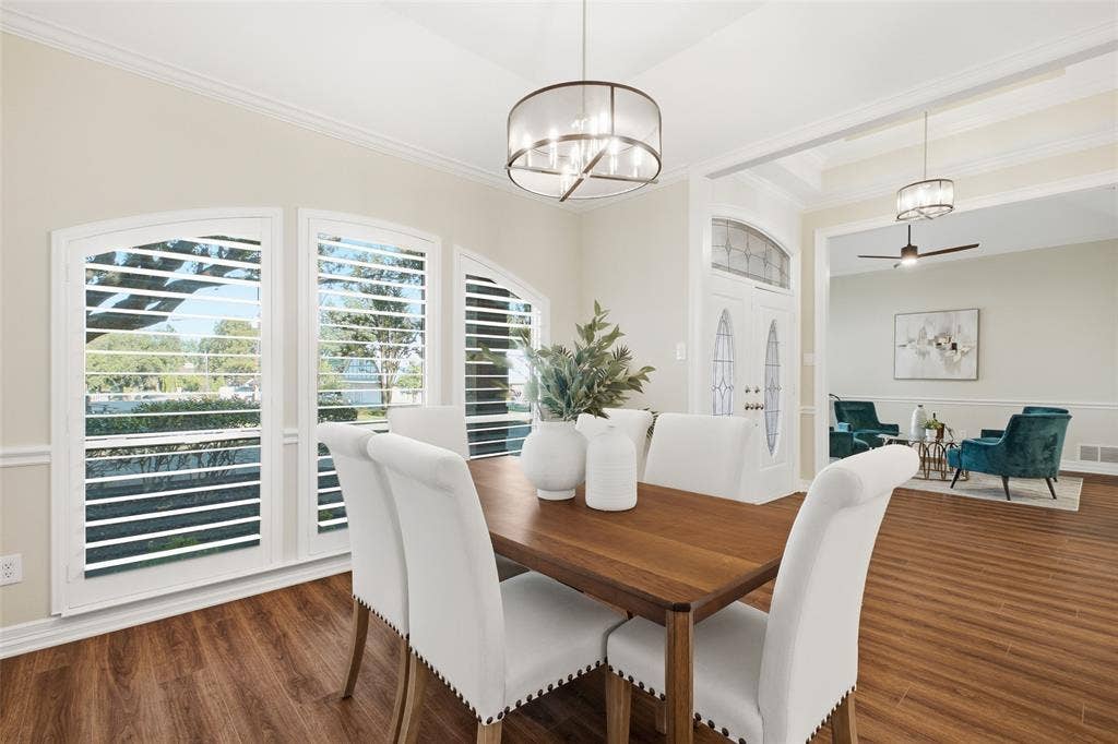 Plantation shutters and a statement chandelier set the stage for holiday dinners and dinner parties.
